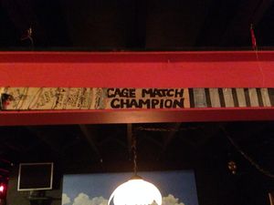 The winners of _The Cagematch_ are recorded on a 2x4 mounted on the wall at ColdTowne Theater.